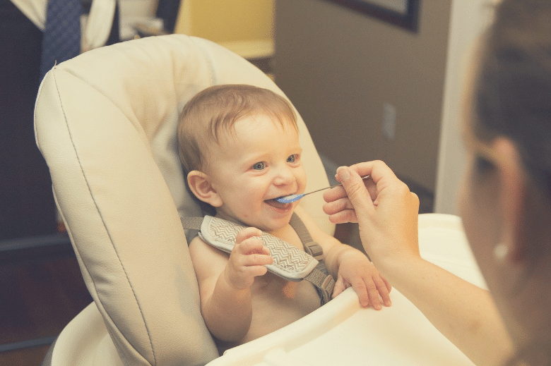 baby starting solids with soft spoon