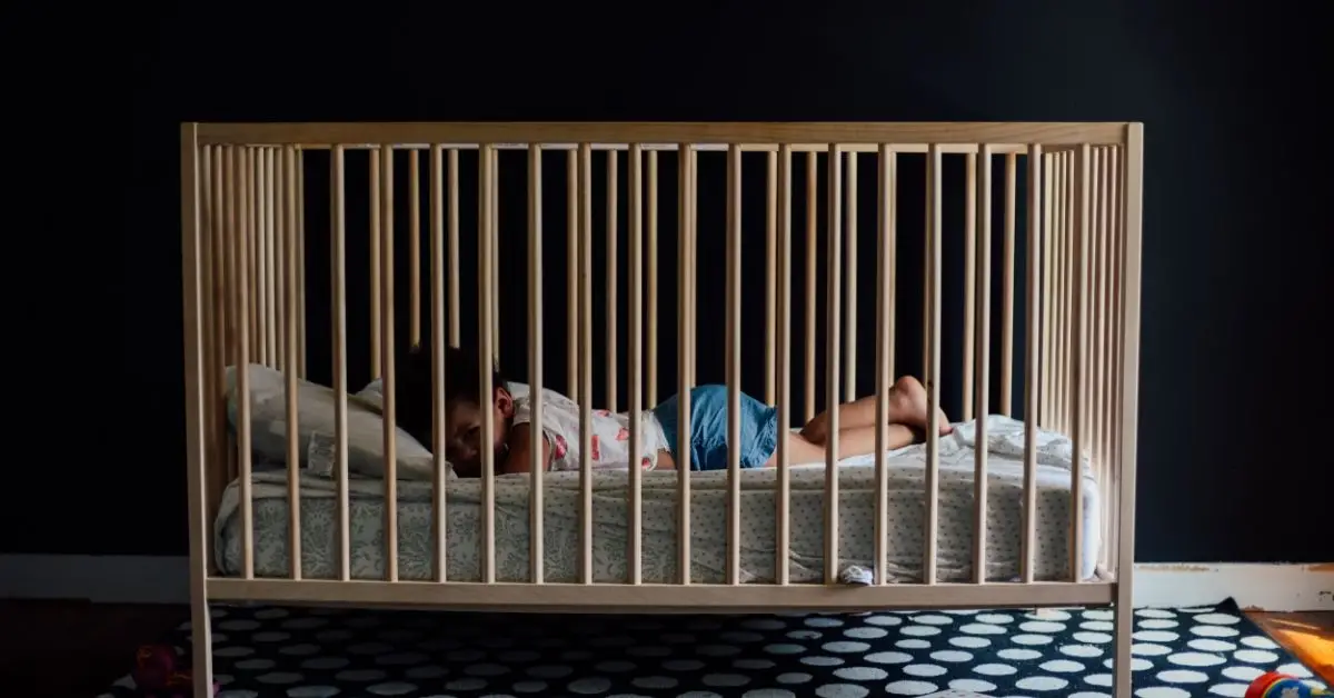 when to lower crib mattress